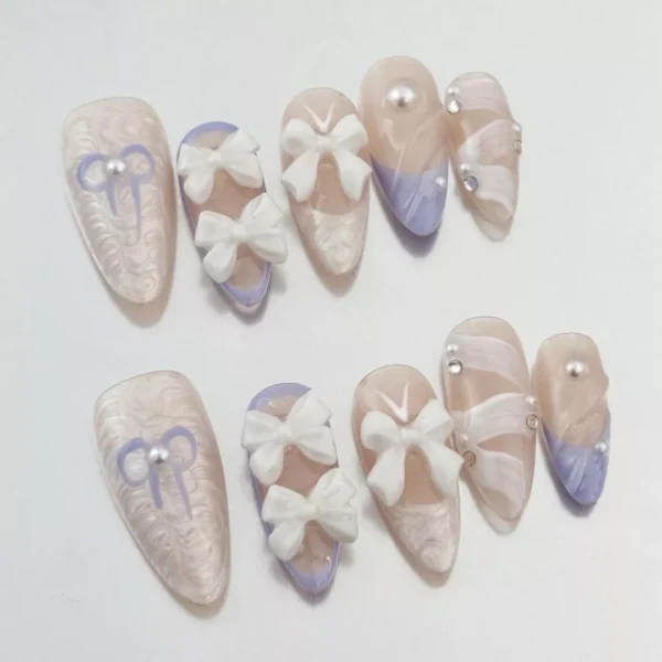 Close-up of White Bow Press-On Nails showcasing sculpted 3D bows and pearl details