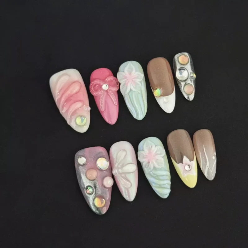 3D Carving Press-On Nails with pastel floral and bow design on black background