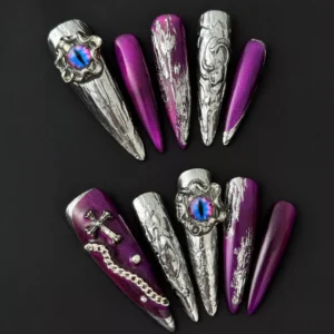 Purple stiletto nail with embedded 3D cat eye jewel and chain detailing