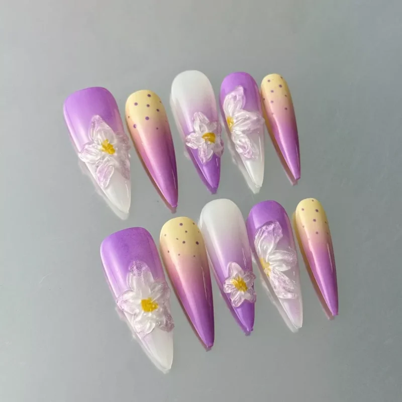 Gradient purple and white press-on nails with sculptural floral details