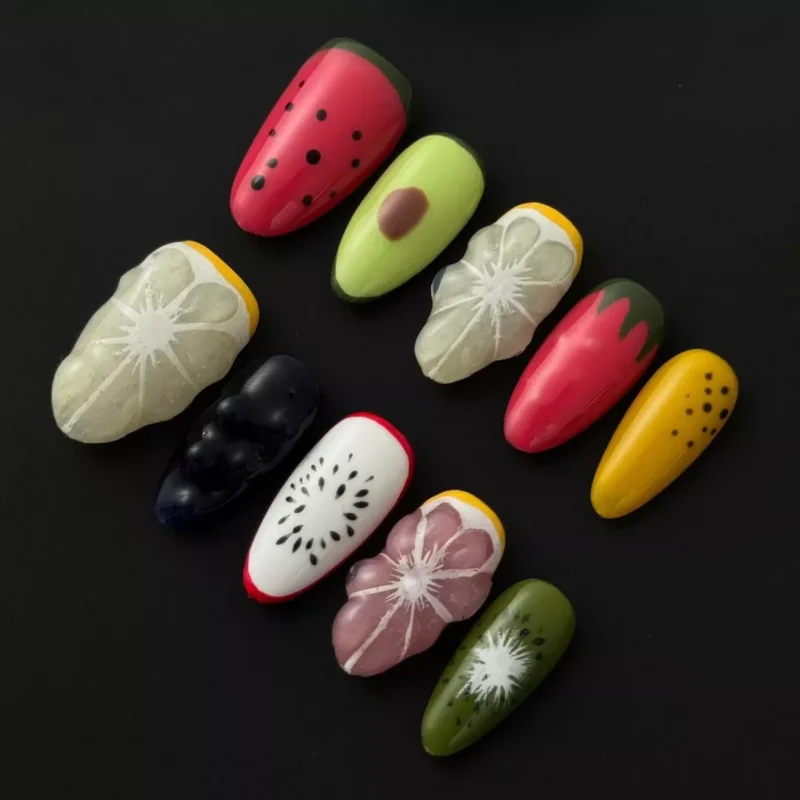 3D fruit press-on nails with glossy finish and colorful sculpted fruit designs – front set display