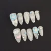 3D White Glitter Press-On Nails with cartoon flower and heart charms – front view