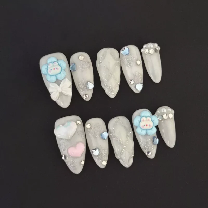 3D White Glitter Press-On Nails with cartoon flower and heart charms – front view