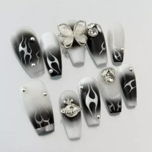 Long almond-shaped Black Gradient Press-On Nails with silver metal accents – angle view