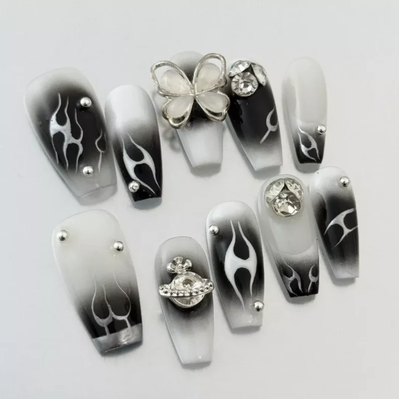 Long almond-shaped Black Gradient Press-On Nails with silver metal accents – angle view