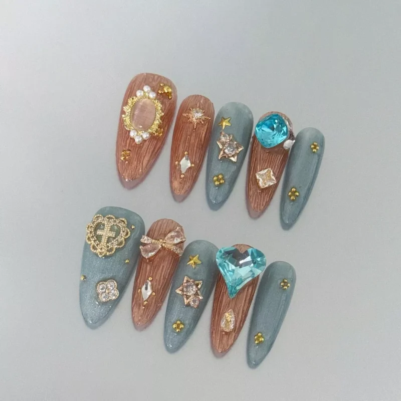 Long Almond Celestial Press-On Nails with golden stars and rhinestones