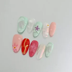Artistic flower press-on nails featuring colorful 3D designs and pastel shades