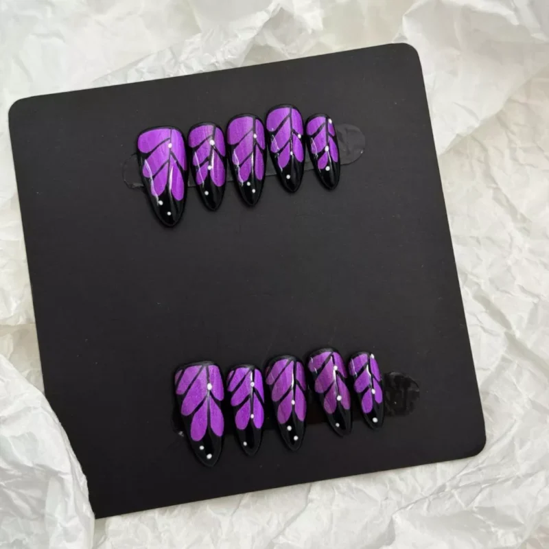 Artistic shot of Glitter Purple Press-On Nails featuring pastel shimmer and black outline design