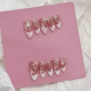 Artistic shot of Pink Flame French Press-On Nails highlighting nude base and pink flame tips