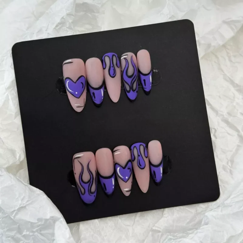 Artistic shot of Purple Flame Heart Press-On Nails featuring a nude background with purple cartoon flames