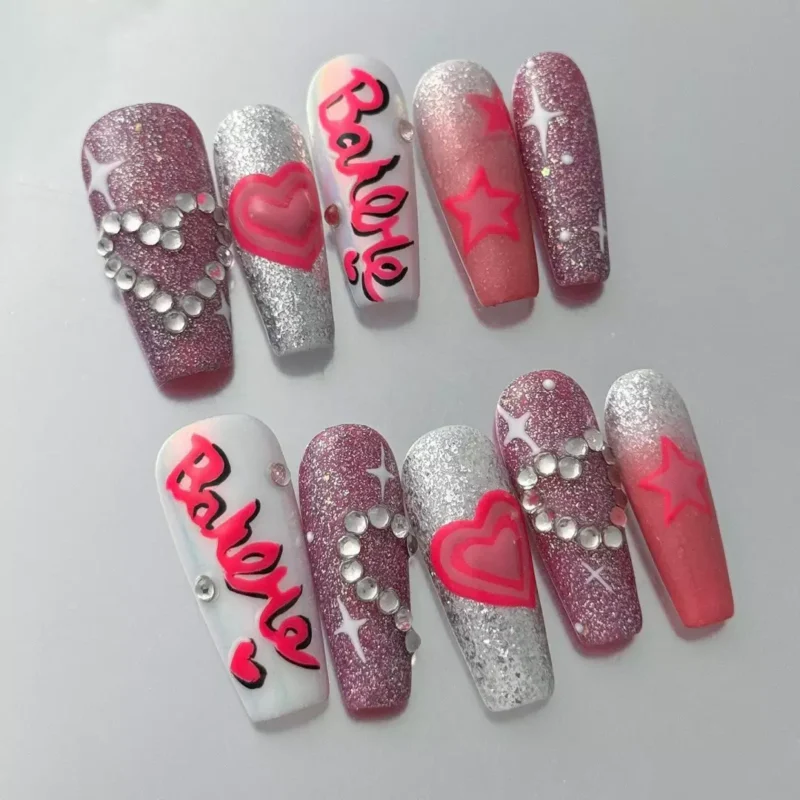 Close-up of Barbie Font Nail Art on glitter pink base with crystal accents