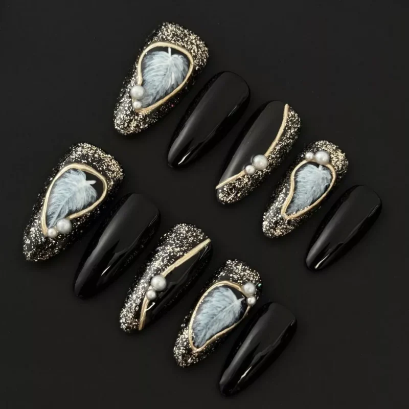Black Glitter Press-On Nails with feather accents and pearl embellishments – frontal view