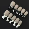 Black and White Floral Press-On Nails – close-up showcasing glitter trim and nude base