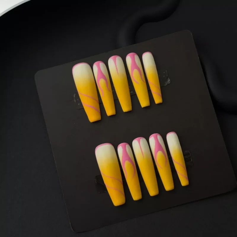 Bold flame press-on nails in yellow, pink, and white matte tones