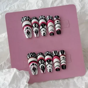 Styled layout of tribal geometric press-on nails with black, white, and red abstract motifs