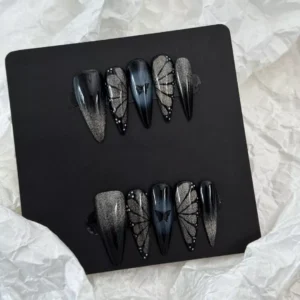 Long gothic butterfly press-on nails on hand – glam styling for photoshoot
