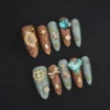Celestial Press-On Nails with blue gems and wood grain texture