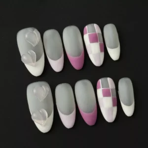 Side angle of cute press-on nails with white checkerboard, pearls, and matte finish