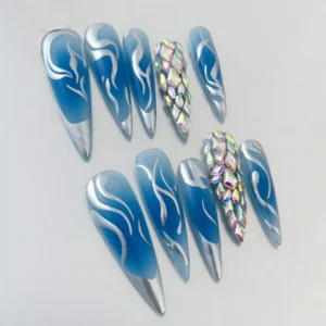 Chrome blue flame press-on nails with rhinestone accents – angled detail shot