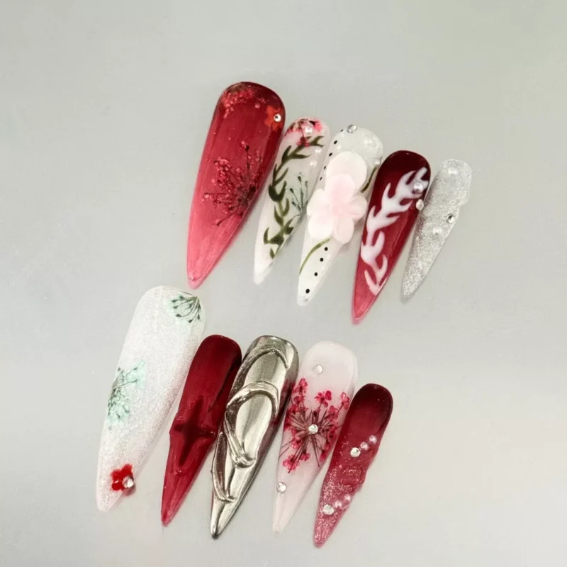 Chrome and glitter floral nails in burgundy and white press-on design