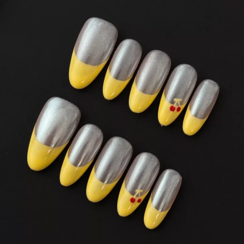 Chrome French Press-On Nails with yellow tips and cherry accents - front view