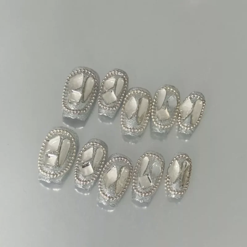 Close-up of chrome square press-on nails with shimmering mirror surface