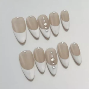 Close-up of rhinestone details on White French Press-On Nails with nude foundation