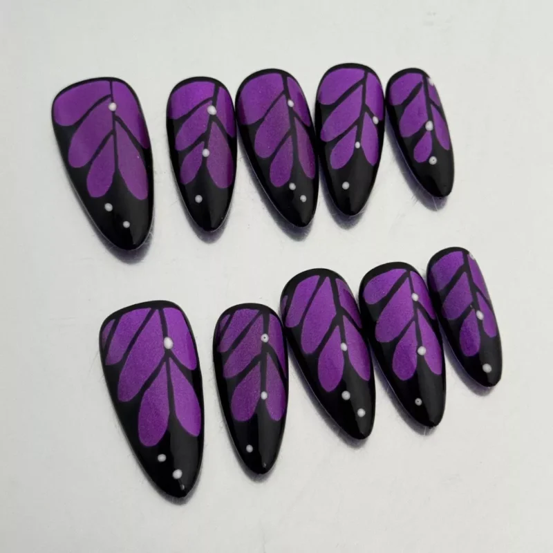 Close-up of Glitter Purple Press-On Nails showing black outlined butterfly wing details
