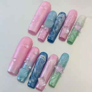Close-up of Underwater Dream Press-On Nails with pastel jellyfish and seashell textures