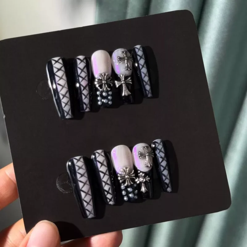 Full set of black gothic cross press-on nails in packaging