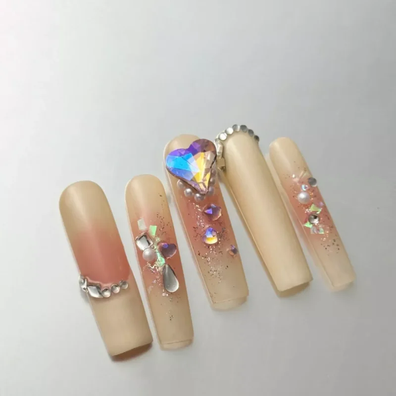 Crystal Heart Press-On Nails with nude ombre base and 3D rhinestone accents on all fingers