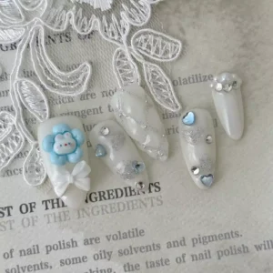 Cute Heart Press-On Nails with white glitter and colorful 3D details – angled side view