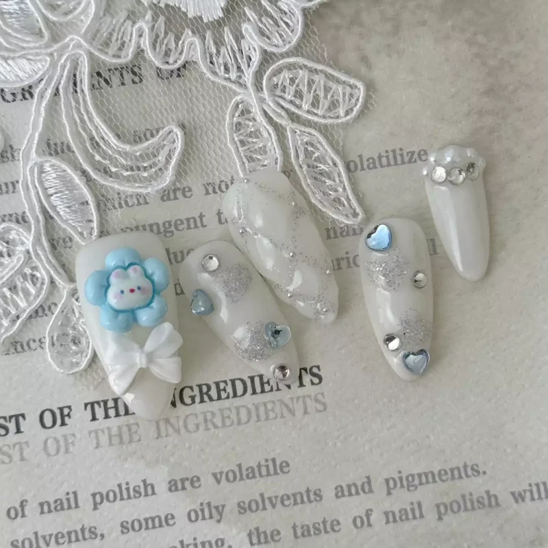 Cute Heart Press-On Nails with white glitter and colorful 3D details – angled side view