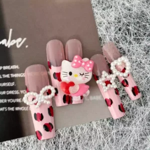 Cute Press-On Nails featuring leopard spots, Hello Kitty charm, and pearl bow ties
