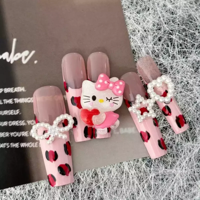 Cute Press-On Nails featuring leopard spots, Hello Kitty charm, and pearl bow ties