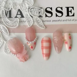 Press-on nails with pink plaid, strawberry art and 3D bow design