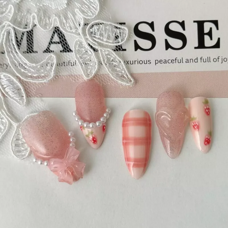 Press-on nails with pink plaid, strawberry art and 3D bow design