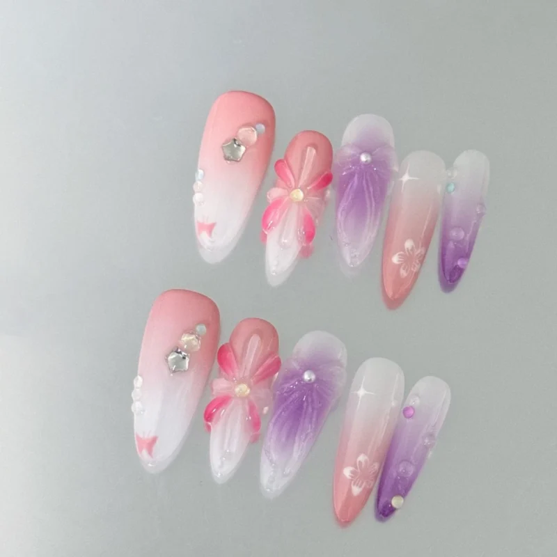 Cute press-on nails in ombre design with floral and jelly heart accents