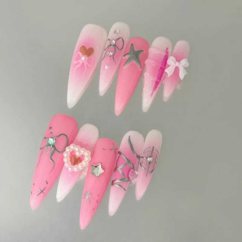Pink gradient press-on nails with 3D star, bow, and pearl detailing