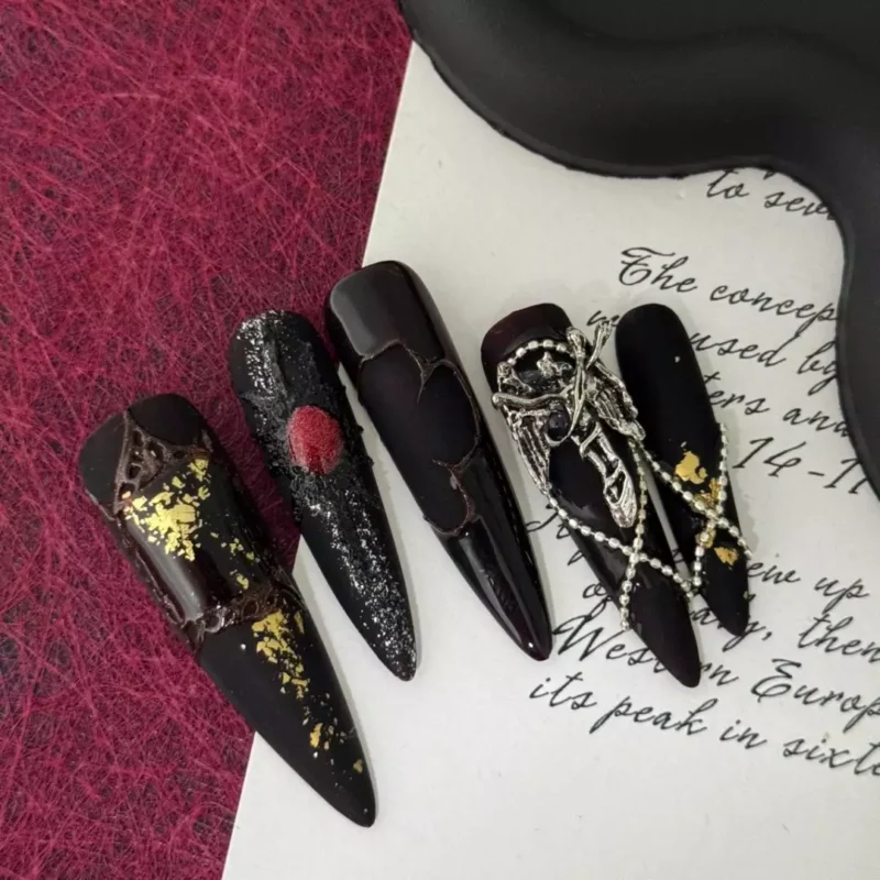 Halloween themed black stiletto press-on nails with gothic charm and foil accents