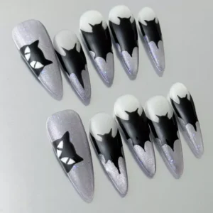 Close-up of black dripping tip on silver glitter stiletto press-on nail with gothic style
