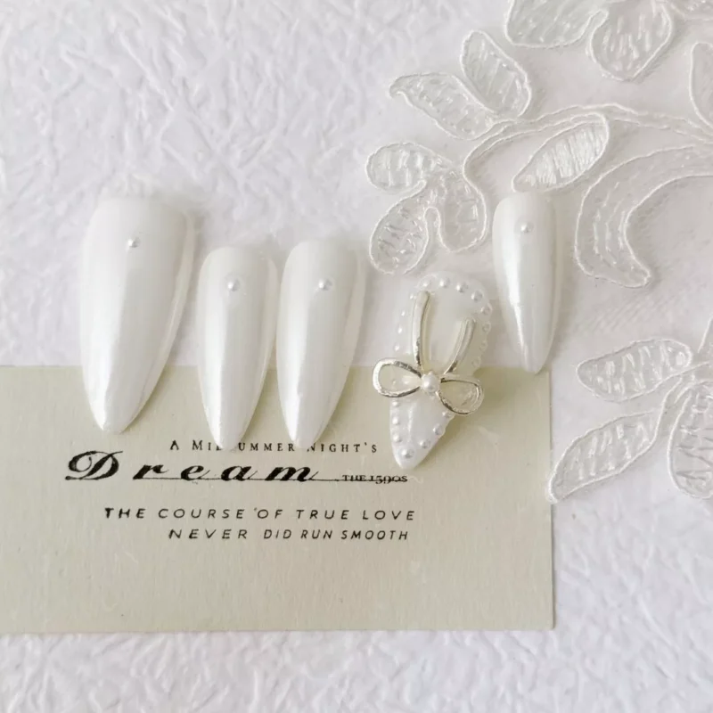 Pearl White Press-On Nails displayed with lace backdrop for elegant styling