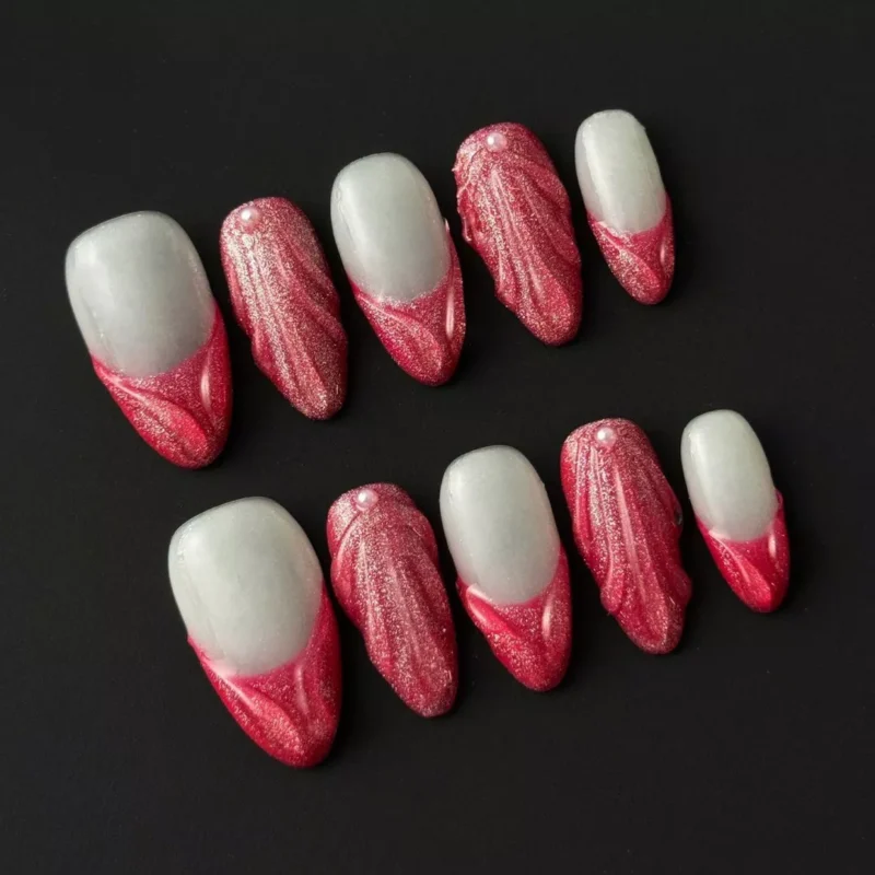 Elegant red press-on nails with textured 3D sculpting and bridal pearl decor