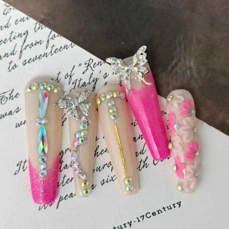 Pink floral press-on nails with 3D butterflies and glitter finish