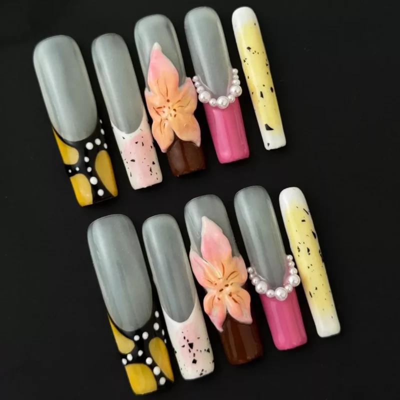 Long almond nails with pastel color swirls and 3D pearl floral charms