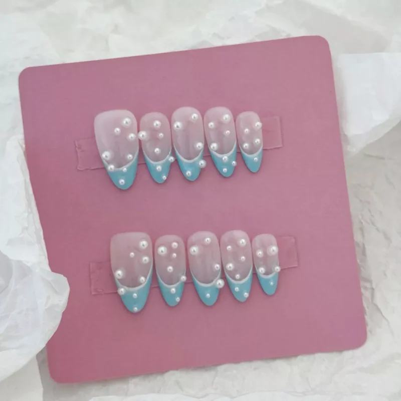 Hand model wearing Frosted Blue Press-On Nails with subtle pearl accents