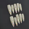 Crystal Bloom Press-On Nails with iridescent rhinestones in pyramid layout on nude stiletto base
