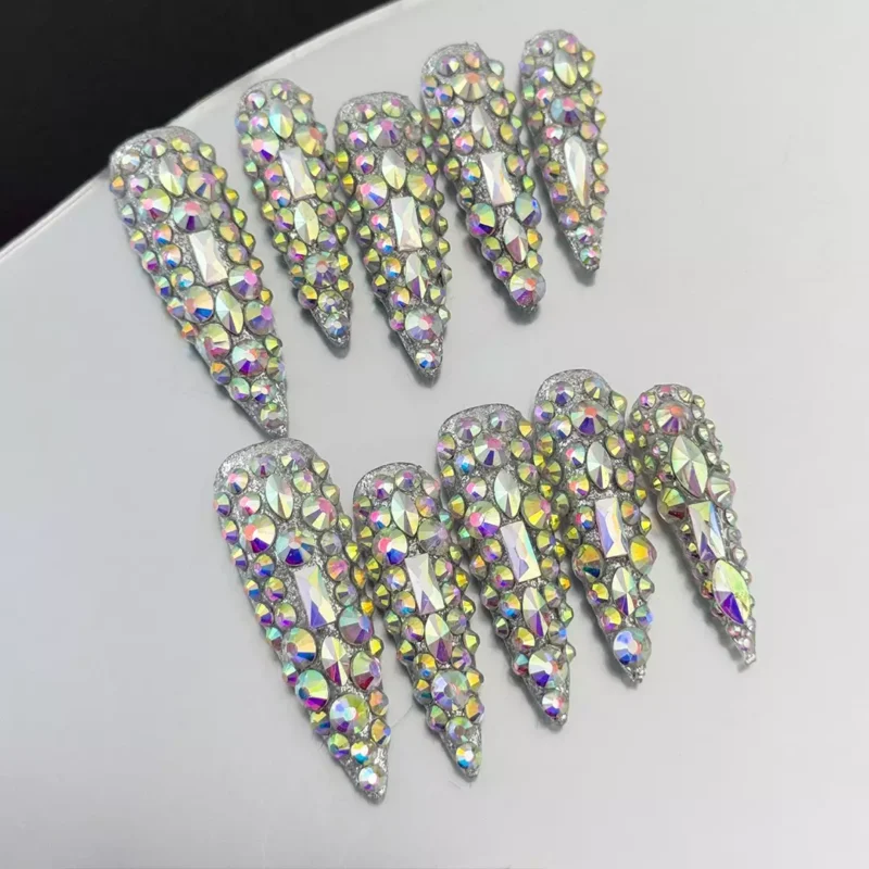 Side angle of stiletto crystal press-on nails showing shine and 3D texture