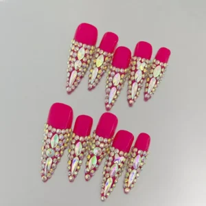 Close-up of crystal-encrusted red stiletto press-on nails
