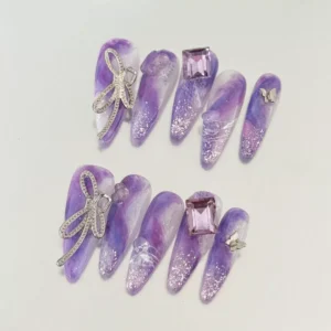 Purple Press-On Nails worn with crystal butterfly accents
